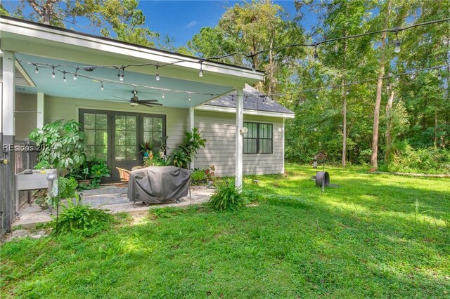 view of yard with a patio and ceiling fan