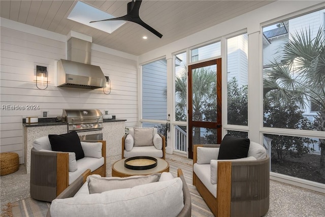 living room featuring wood ceiling, ceiling fan, and wood walls