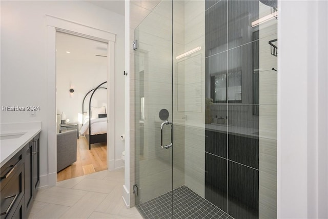 bathroom with a shower with door and vanity