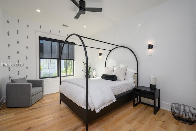 bedroom with ceiling fan and light hardwood / wood-style floors