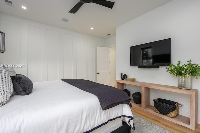 bedroom with hardwood / wood-style floors and ceiling fan