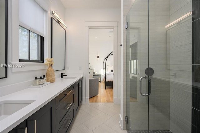 bathroom featuring vanity and a shower with shower door