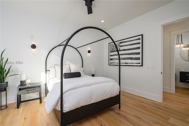 bedroom with ceiling fan and light hardwood / wood-style flooring