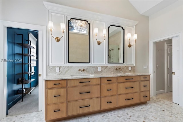 bathroom featuring lofted ceiling, vanity, and decorative backsplash