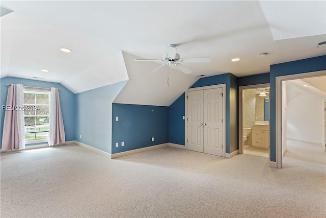 bonus room featuring ceiling fan, vaulted ceiling, and light carpet