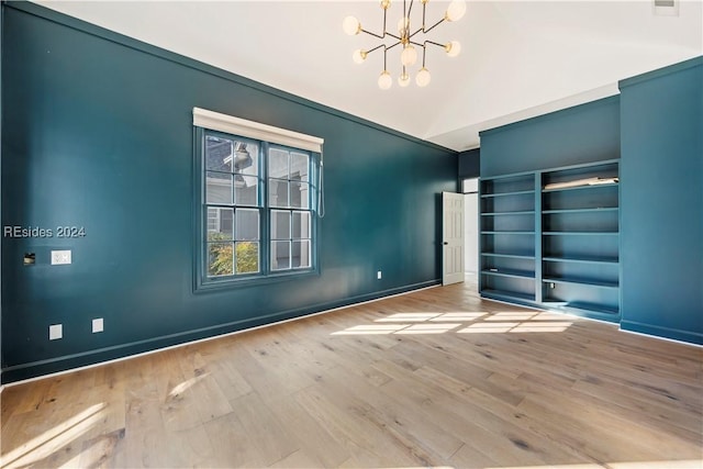 unfurnished bedroom featuring an inviting chandelier and light wood-type flooring