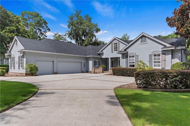 view of front of house with a garage and a front yard