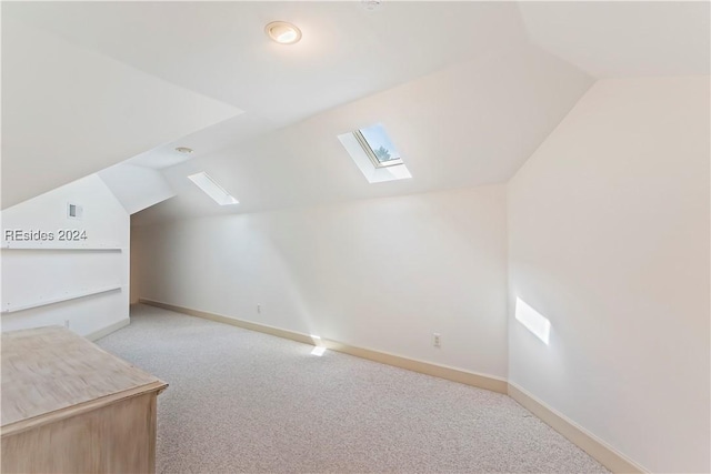 bonus room featuring lofted ceiling and light colored carpet