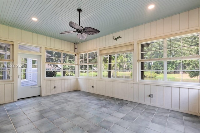 unfurnished sunroom with ceiling fan