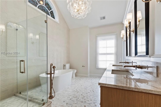 bathroom featuring an inviting chandelier, vanity, and plus walk in shower