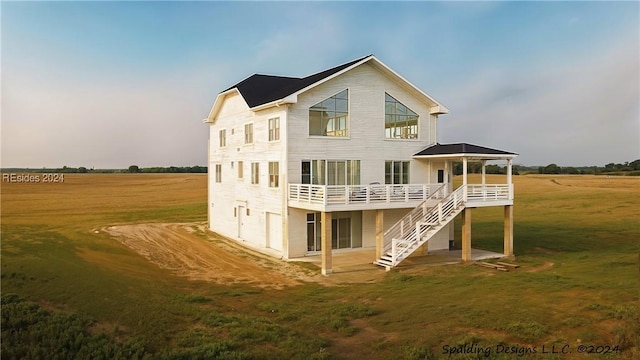 rear view of property featuring a wooden deck and a lawn