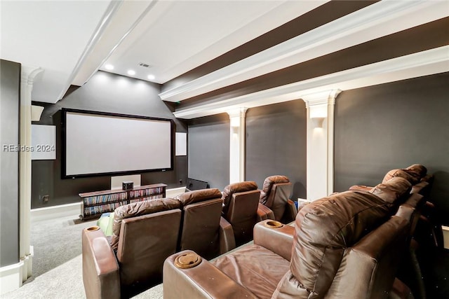 carpeted home theater room with ornamental molding and decorative columns