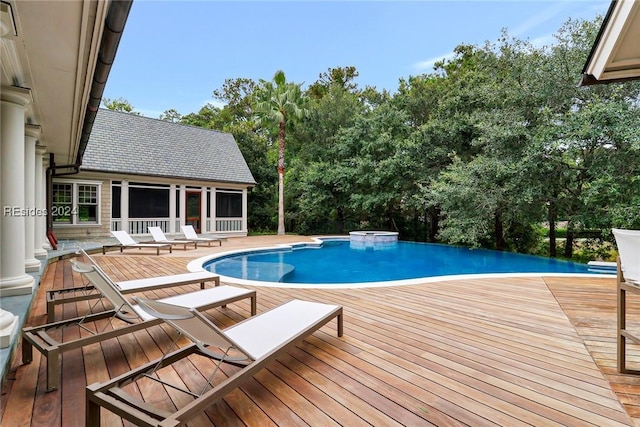 view of pool with a hot tub and a deck