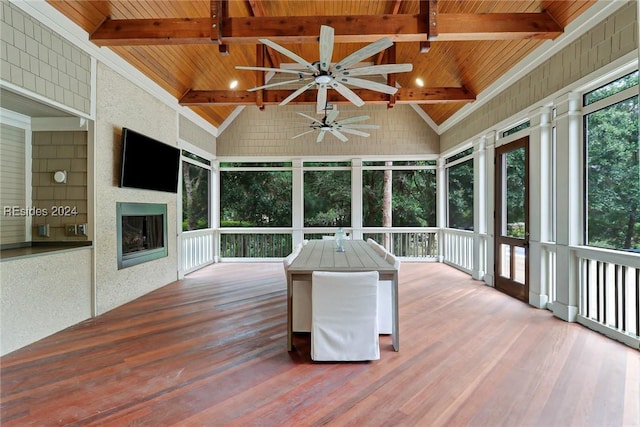 unfurnished sunroom with vaulted ceiling with beams and wood ceiling