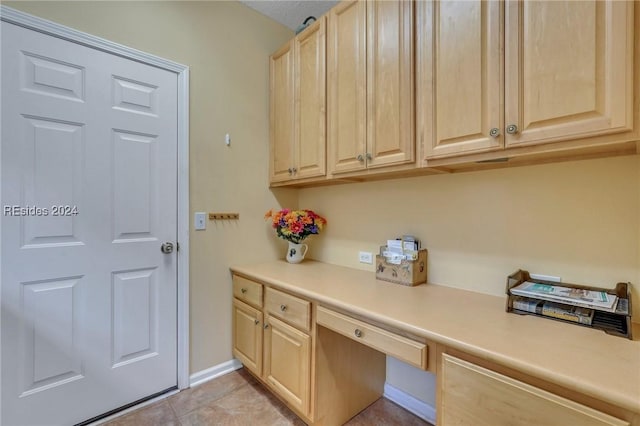 clothes washing area featuring light tile patterned flooring