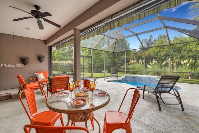 view of patio with ceiling fan and glass enclosure