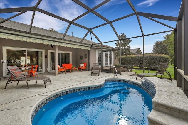 view of swimming pool featuring a lanai and a patio area