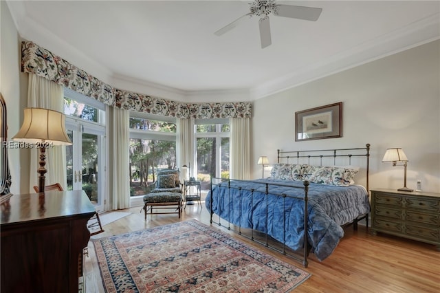 bedroom with ornamental molding, light wood-type flooring, and ceiling fan