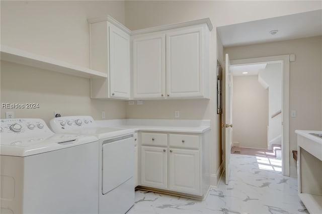 laundry area with cabinets and washing machine and clothes dryer