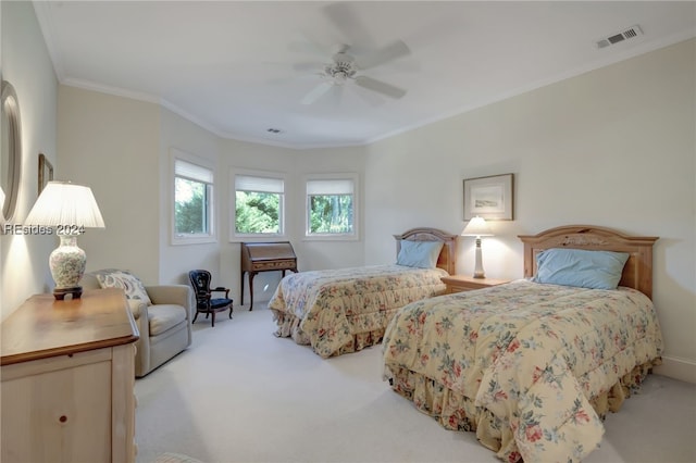 carpeted bedroom with ornamental molding and ceiling fan