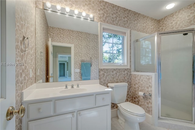 bathroom featuring vanity, tile patterned flooring, a shower with door, and toilet