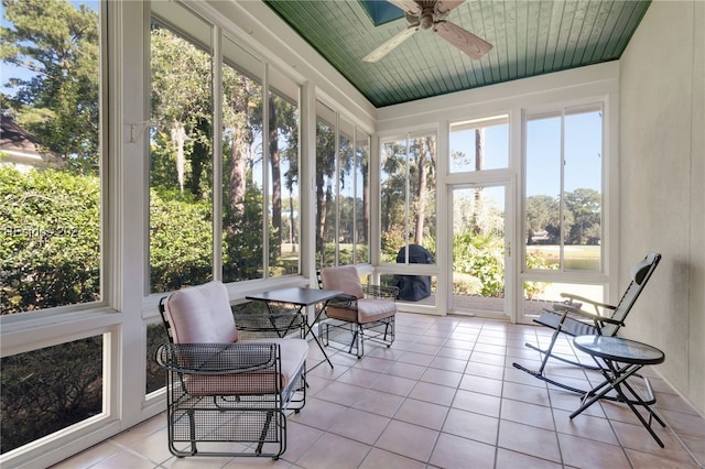 sunroom / solarium with ceiling fan and a healthy amount of sunlight