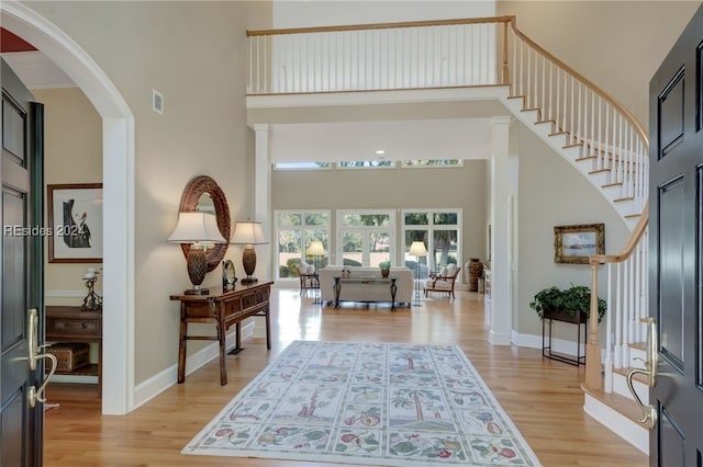 entrance foyer with light hardwood / wood-style flooring and a high ceiling