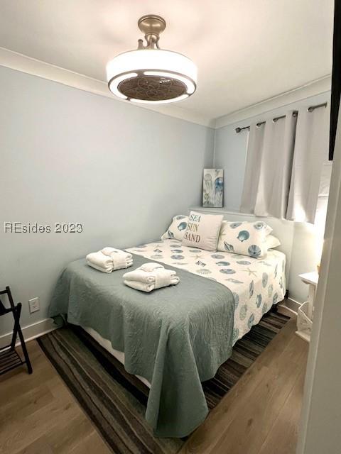 bedroom featuring crown molding and hardwood / wood-style floors