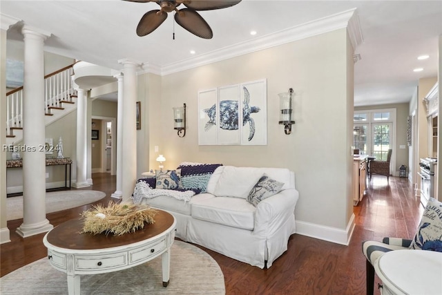 living room with decorative columns, crown molding, dark hardwood / wood-style floors, and ceiling fan