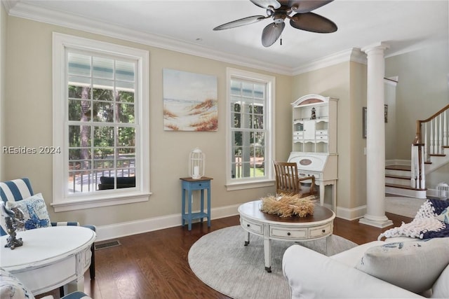 living area featuring ornamental molding, decorative columns, dark hardwood / wood-style floors, and ceiling fan