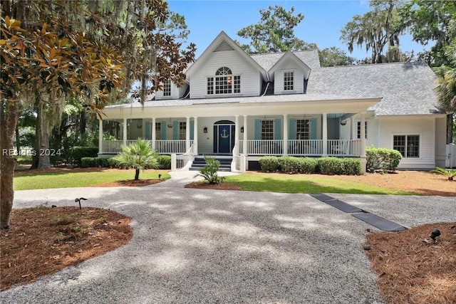 farmhouse with a porch and a front yard