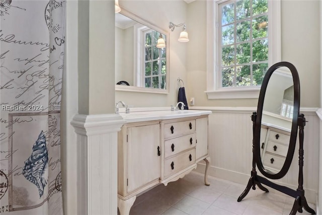 bathroom featuring a shower with curtain, plenty of natural light, tile patterned flooring, and vanity