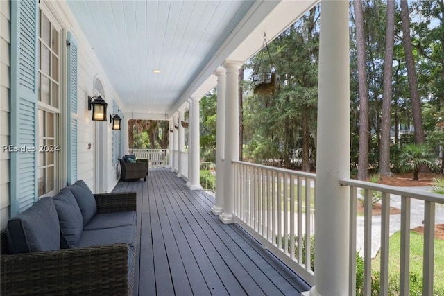 wooden terrace featuring covered porch