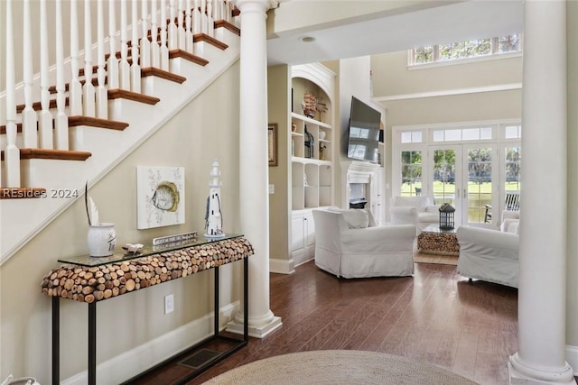 interior space with hardwood / wood-style floors and ornate columns