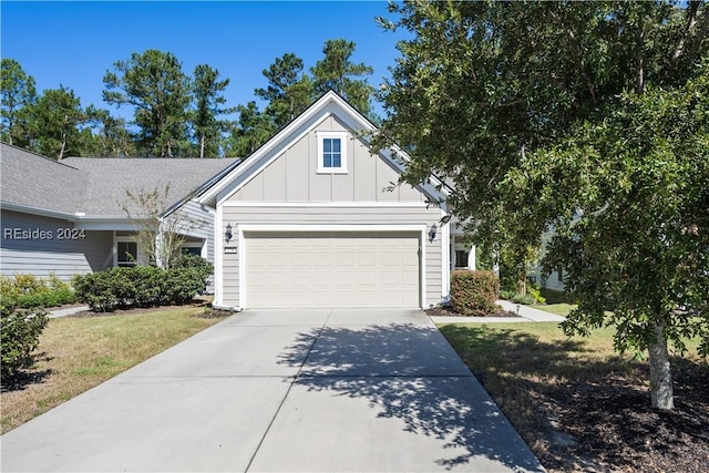 view of front of property featuring a garage and a front lawn