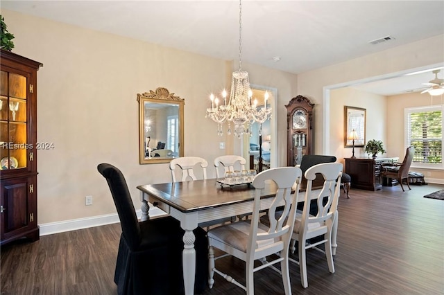 dining space featuring dark hardwood / wood-style flooring and ceiling fan with notable chandelier