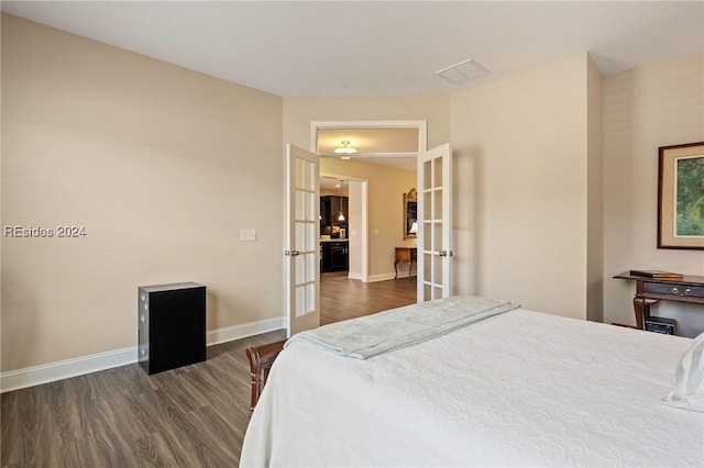 bedroom featuring french doors and dark hardwood / wood-style flooring