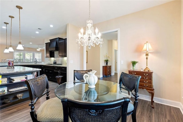 dining room with an inviting chandelier and hardwood / wood-style flooring