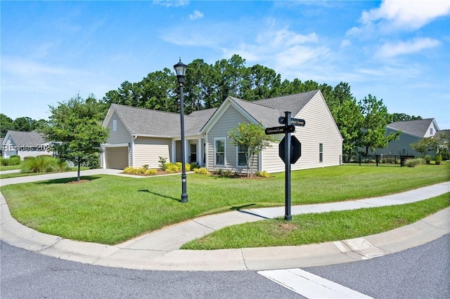 view of front of property with a garage and a front yard