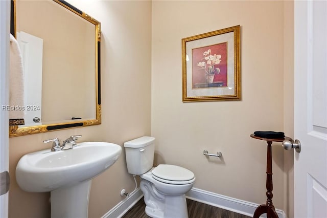 bathroom with wood-type flooring and toilet