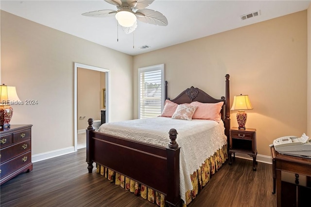 bedroom featuring dark wood-type flooring, ceiling fan, and ensuite bathroom