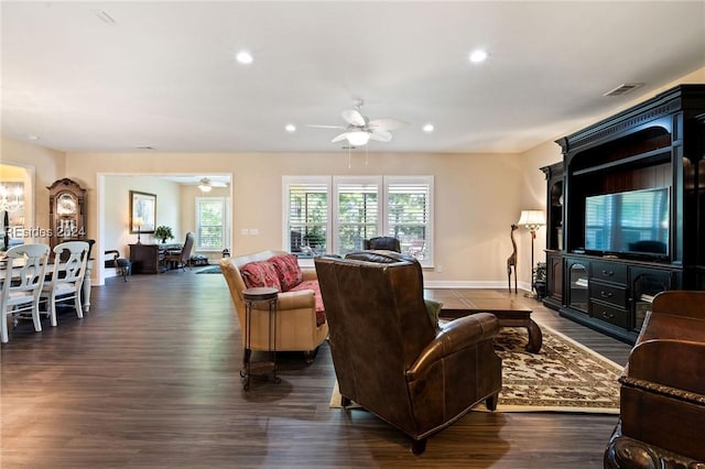 living room with dark hardwood / wood-style floors and ceiling fan