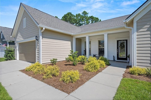 property entrance featuring a garage and a porch