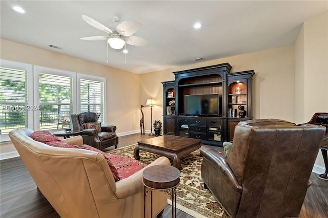 living room with dark hardwood / wood-style floors and ceiling fan