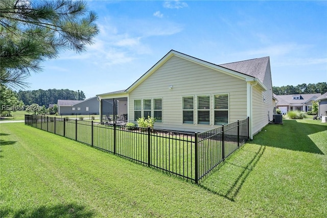 back of house featuring central AC and a lawn