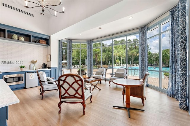 sunroom with a notable chandelier