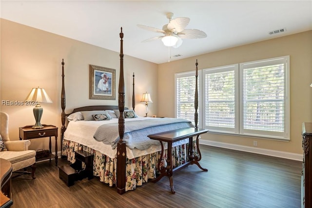 bedroom with dark hardwood / wood-style flooring and ceiling fan