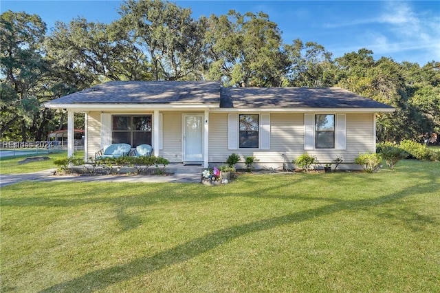 ranch-style house with covered porch and a front yard