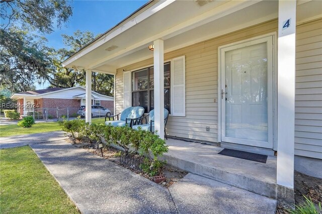 doorway to property featuring covered porch