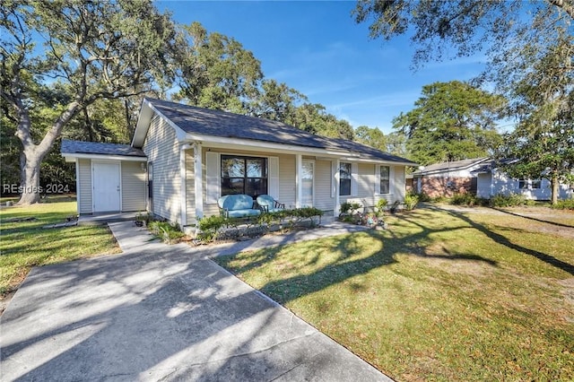 ranch-style house with a porch and a front lawn